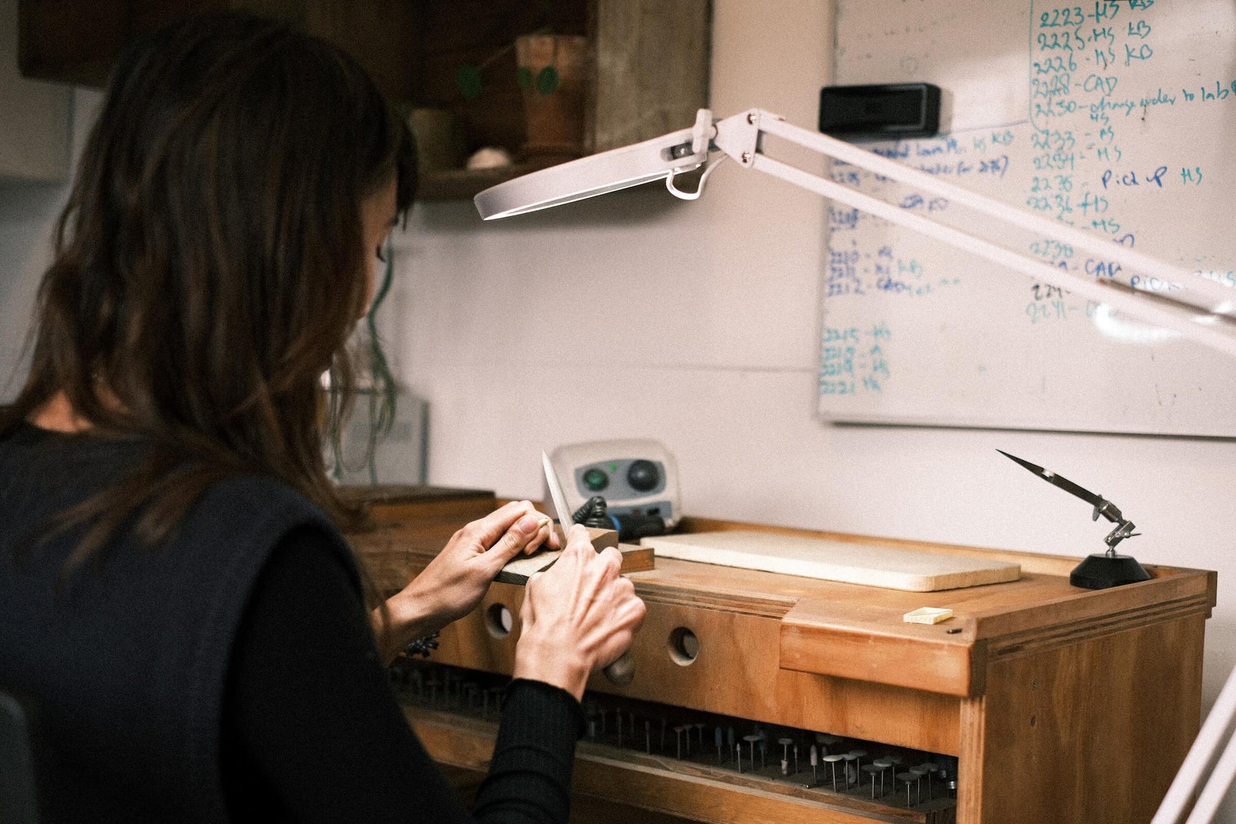 Jeweller working at a bench in the workshop
