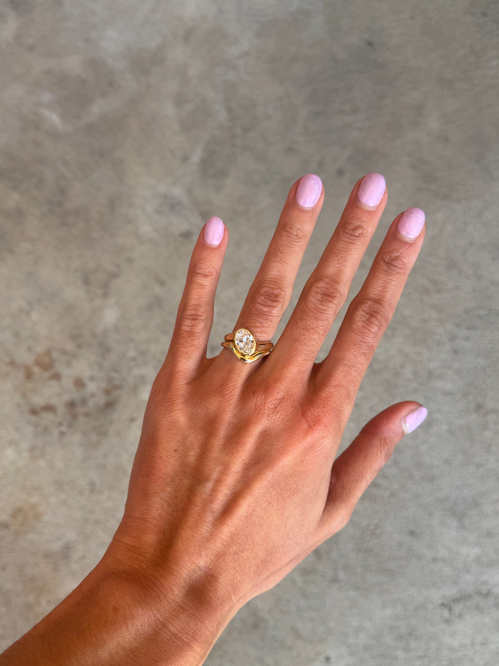 Gold ring asymmetric design with oval diamond and matching paired wedding band, solid gold on hand