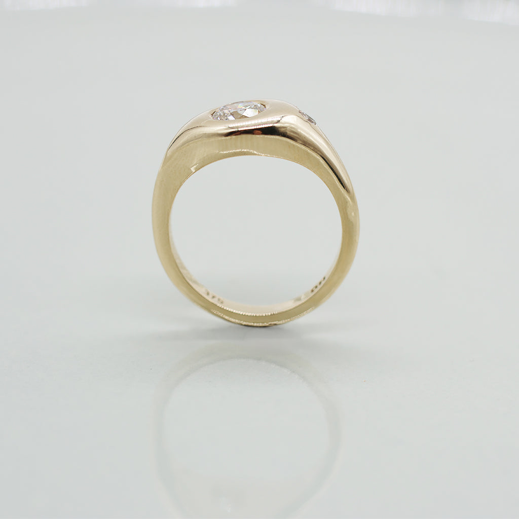 Gold ring with a diamond on a white background