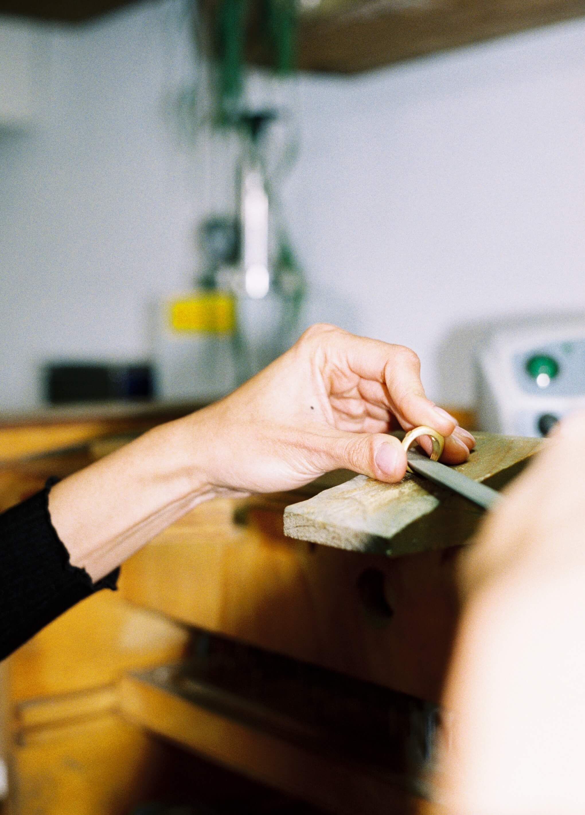 Person shaping a gold ring during production