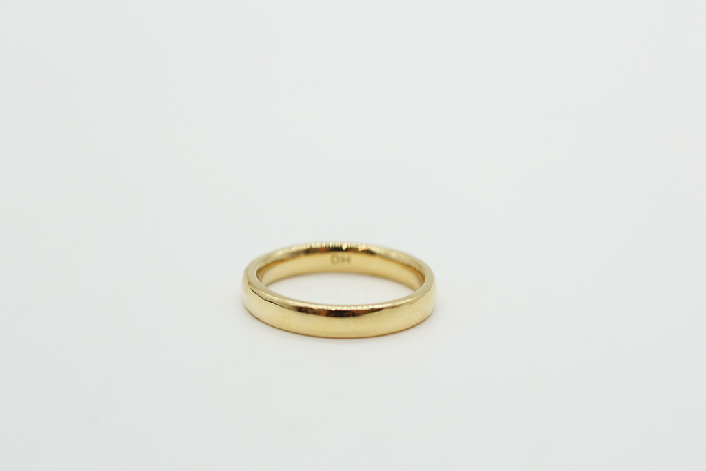Gold ring on a light gray background