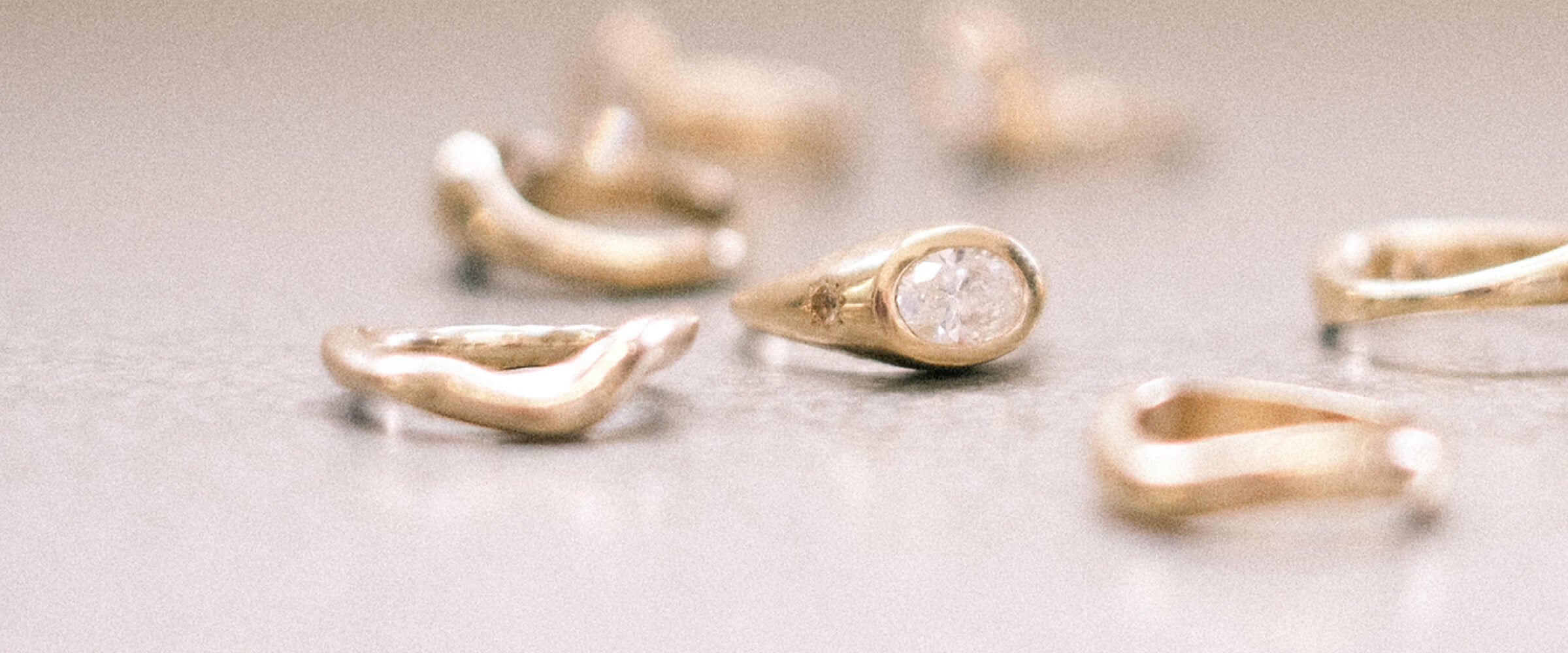 Gold rings scattered across a textured surface