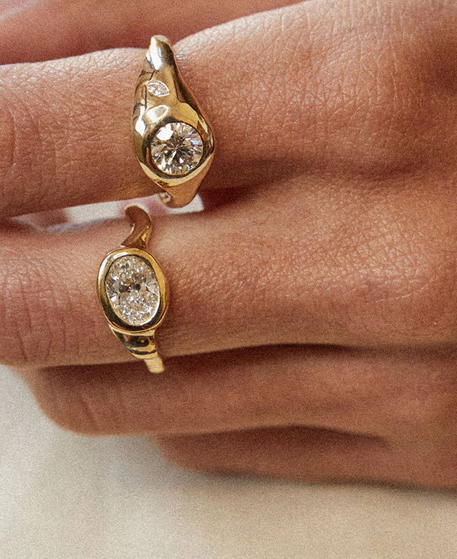 Gold rings with diamond stones on a person's fingers